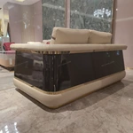 Cream Leather Sofa with Dark High-Gloss Wood Panels, Monogram Cushions and Metal Base Trim